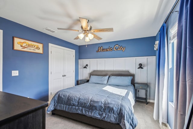 bedroom featuring light carpet, a closet, and ceiling fan