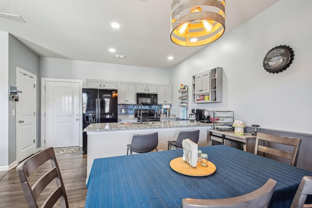 dining room with dark hardwood / wood-style floors and sink