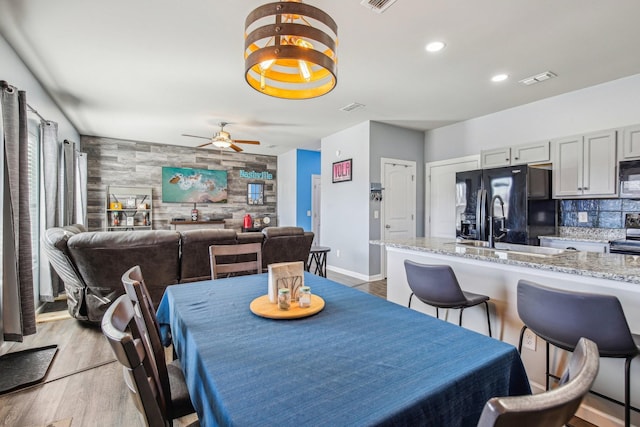 dining space featuring light hardwood / wood-style flooring and ceiling fan