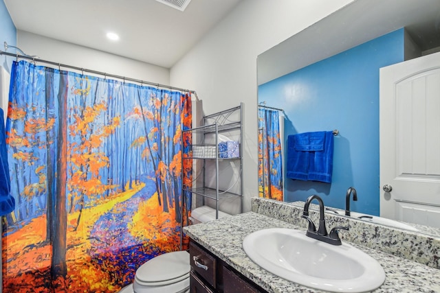 bathroom featuring vanity, curtained shower, and toilet