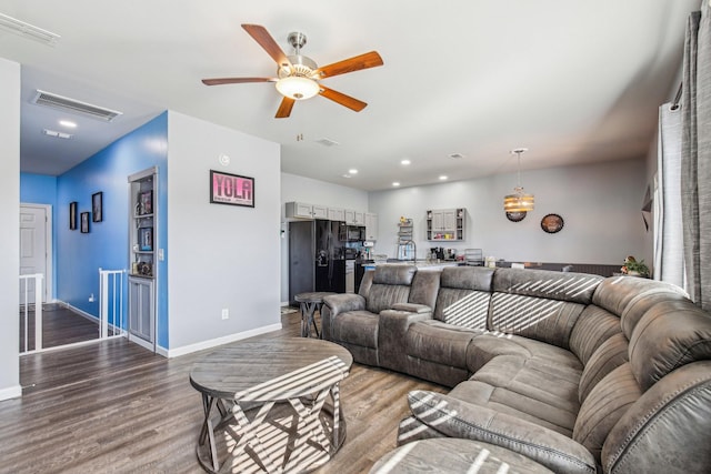 living room featuring hardwood / wood-style floors and ceiling fan