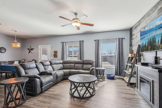 living room featuring hardwood / wood-style floors and ceiling fan