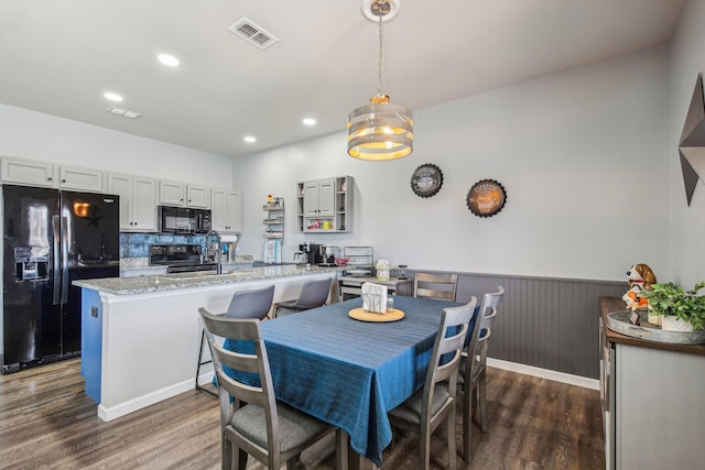 dining area featuring sink and dark hardwood / wood-style flooring