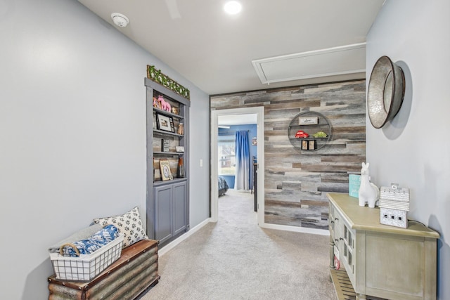 hallway with light colored carpet and wooden walls