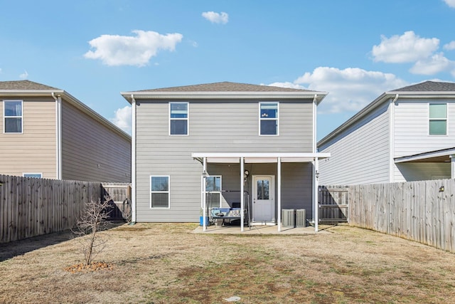 back of house featuring a yard and a patio area