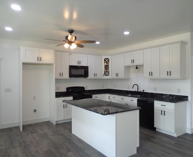 kitchen featuring sink, black appliances, a center island, and white cabinets