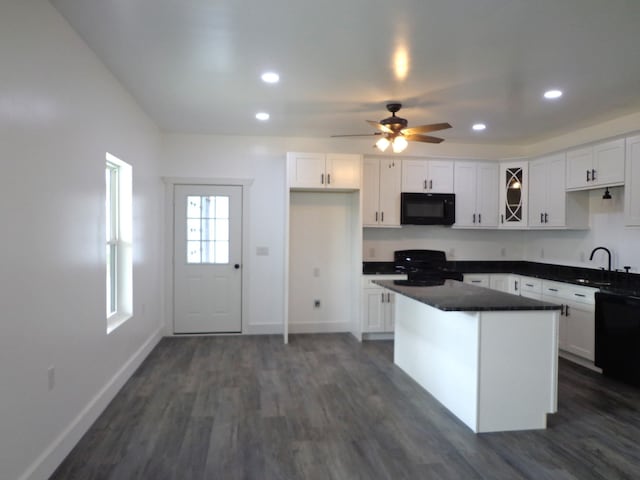 kitchen with sink, ceiling fan, white cabinetry, dark hardwood / wood-style floors, and black appliances