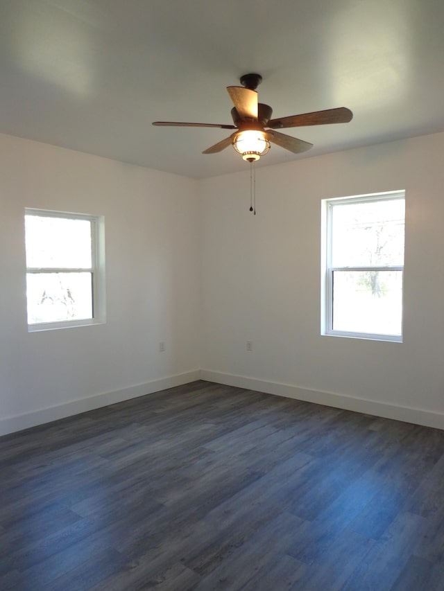 spare room with dark wood-type flooring and ceiling fan