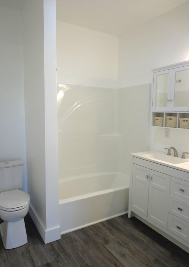 full bathroom with vanity, toilet, tub / shower combination, and hardwood / wood-style floors