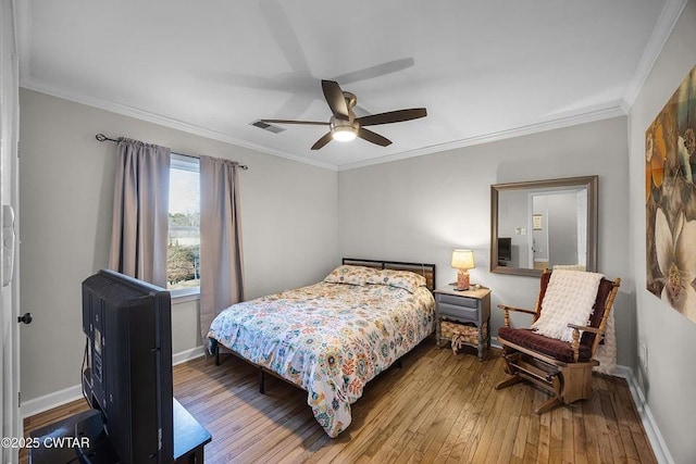 bedroom featuring crown molding, hardwood / wood-style flooring, and ceiling fan