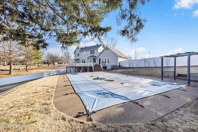 view of swimming pool featuring a pergola and a deck