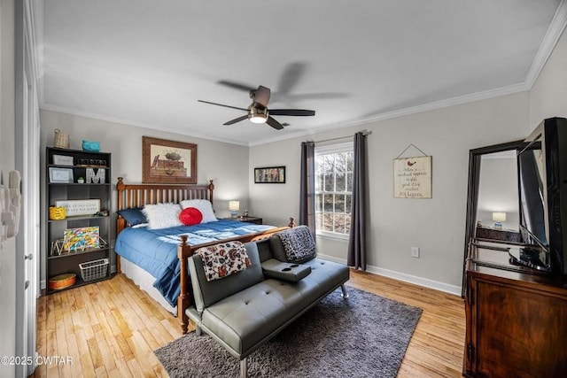 bedroom with crown molding, hardwood / wood-style flooring, and ceiling fan