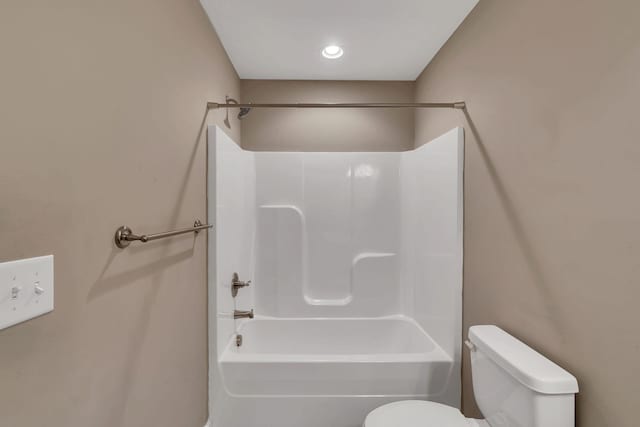 bathroom featuring shower / bathing tub combination and toilet