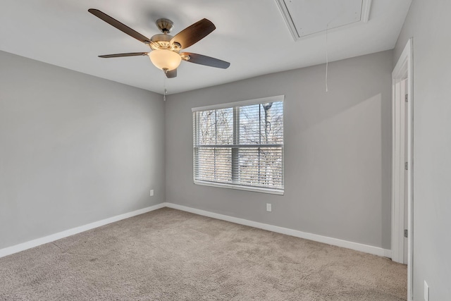 carpeted spare room featuring ceiling fan