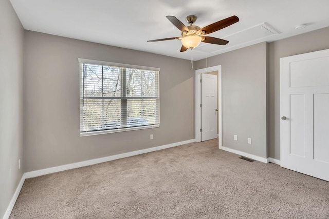 spare room featuring light carpet and ceiling fan