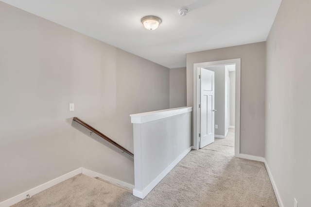 hallway with light carpet