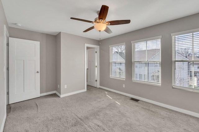 unfurnished bedroom with light carpet and ceiling fan