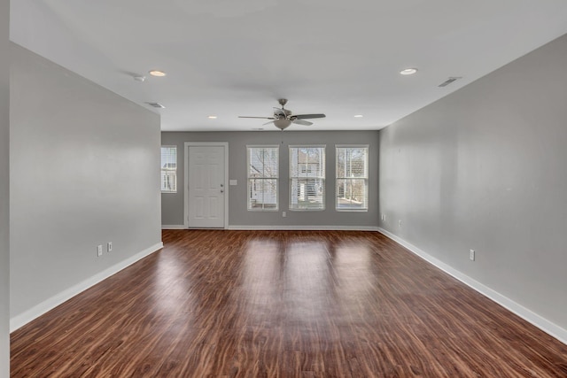 unfurnished living room featuring dark hardwood / wood-style floors and ceiling fan