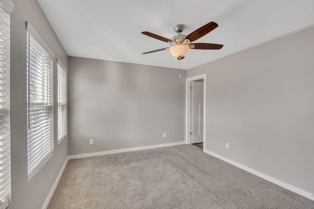 spare room with carpet floors and ceiling fan