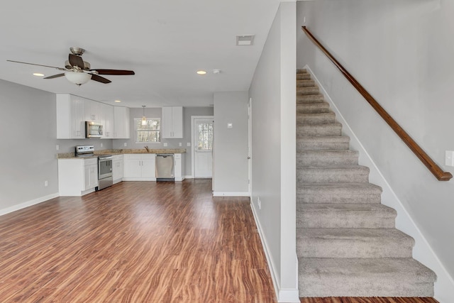 interior space featuring sink, hardwood / wood-style floors, and ceiling fan