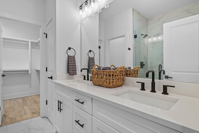 bathroom with walk in shower and vanity