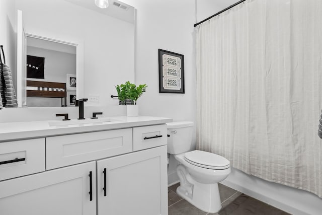 full bathroom with vanity, toilet, tile patterned floors, and shower / bath combo with shower curtain