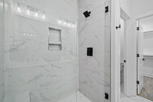 bathroom featuring a shower with shower door