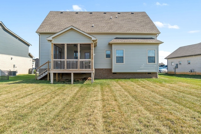 back of property featuring a sunroom, a yard, and cooling unit