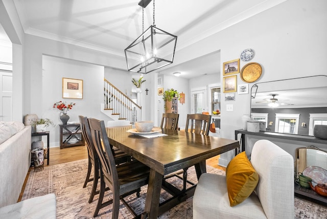 dining space featuring hardwood / wood-style floors, crown molding, and a healthy amount of sunlight