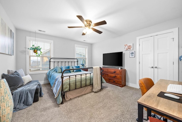 bedroom with ceiling fan, a closet, and carpet