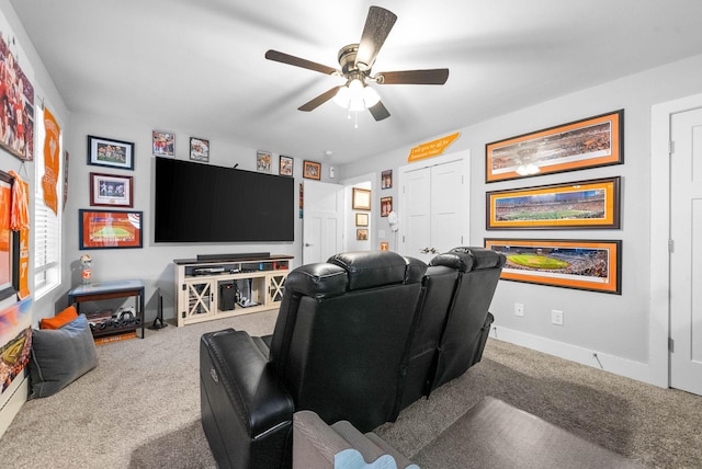 cinema room featuring ceiling fan and carpet floors