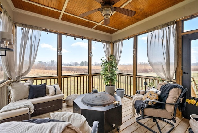 sunroom featuring plenty of natural light, a rural view, and wood ceiling