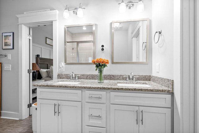 bathroom featuring vanity and an enclosed shower