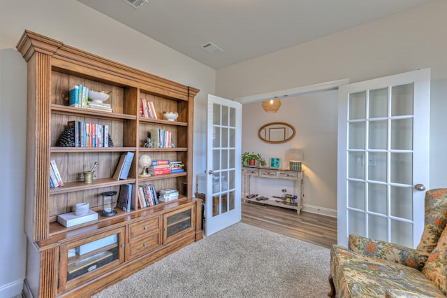 living area featuring carpet flooring and french doors