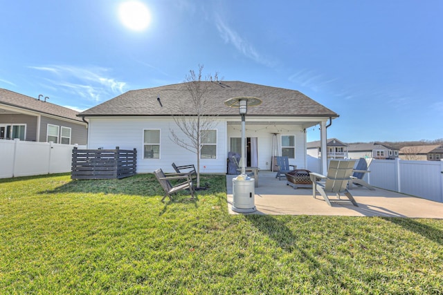 back of house featuring an outdoor fire pit, a patio, and a lawn