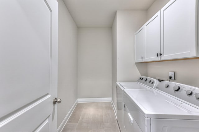 laundry area with cabinets and separate washer and dryer