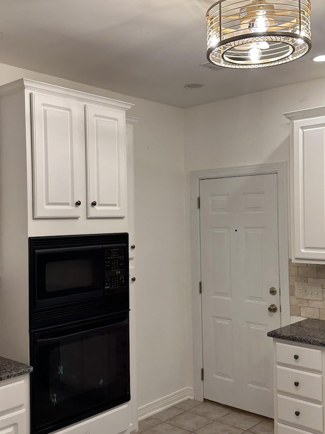 kitchen featuring white cabinetry, pendant lighting, light tile patterned floors, and black appliances