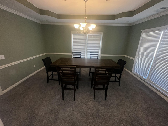 carpeted dining space featuring an inviting chandelier and a tray ceiling