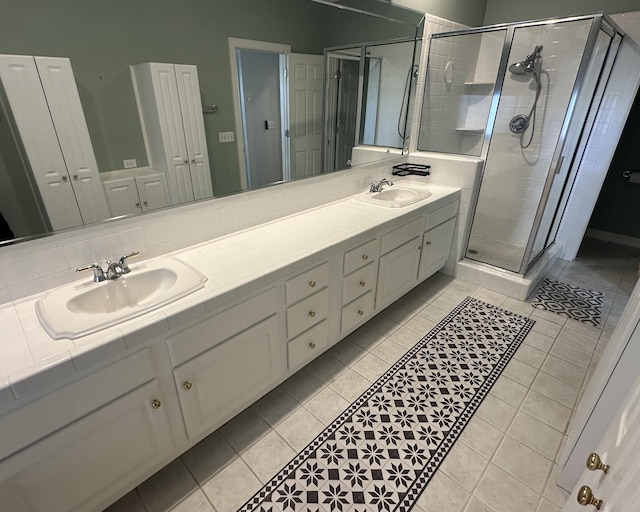 bathroom with vanity, an enclosed shower, and tile patterned flooring