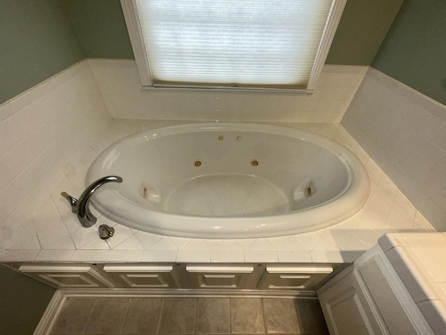 bathroom with a relaxing tiled tub