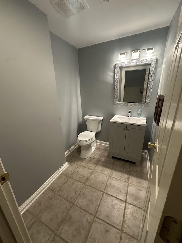 bathroom with vanity, tile patterned floors, and toilet