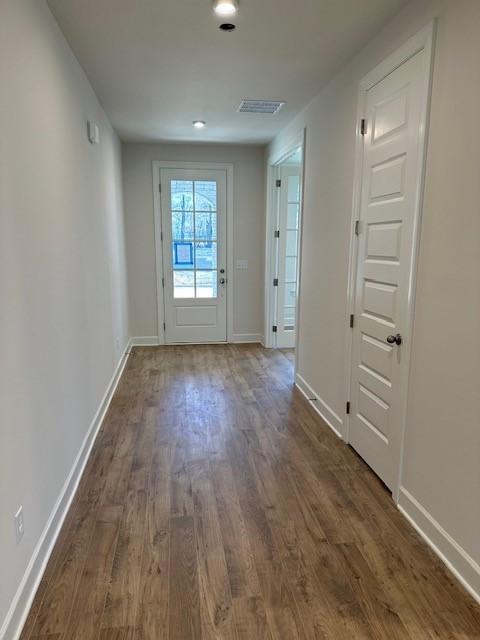 entryway with dark hardwood / wood-style flooring