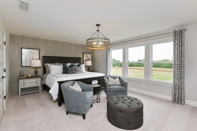 carpeted bedroom featuring a notable chandelier