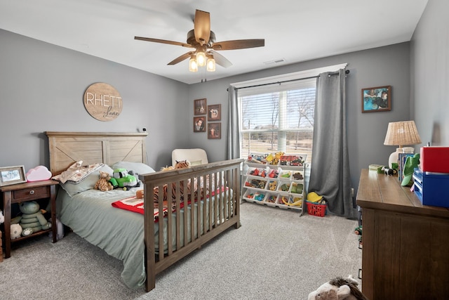 bedroom featuring ceiling fan and carpet