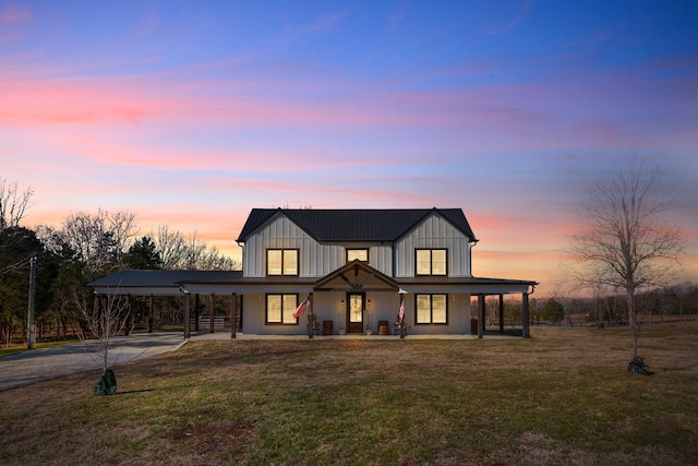 modern inspired farmhouse featuring a porch and a lawn