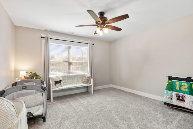 living area featuring carpet floors and ceiling fan