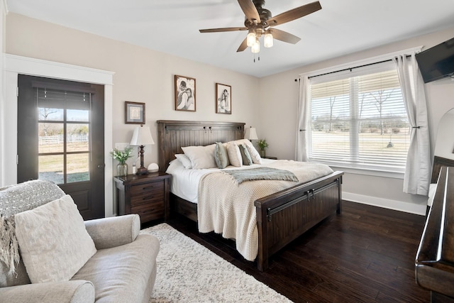 bedroom with dark wood-type flooring, ceiling fan, and access to exterior