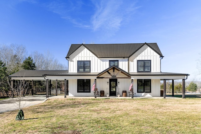 modern farmhouse featuring covered porch and a front yard