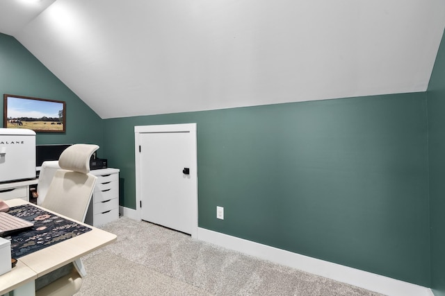 carpeted office featuring lofted ceiling