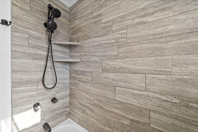 interior details featuring tiled shower / bath combo